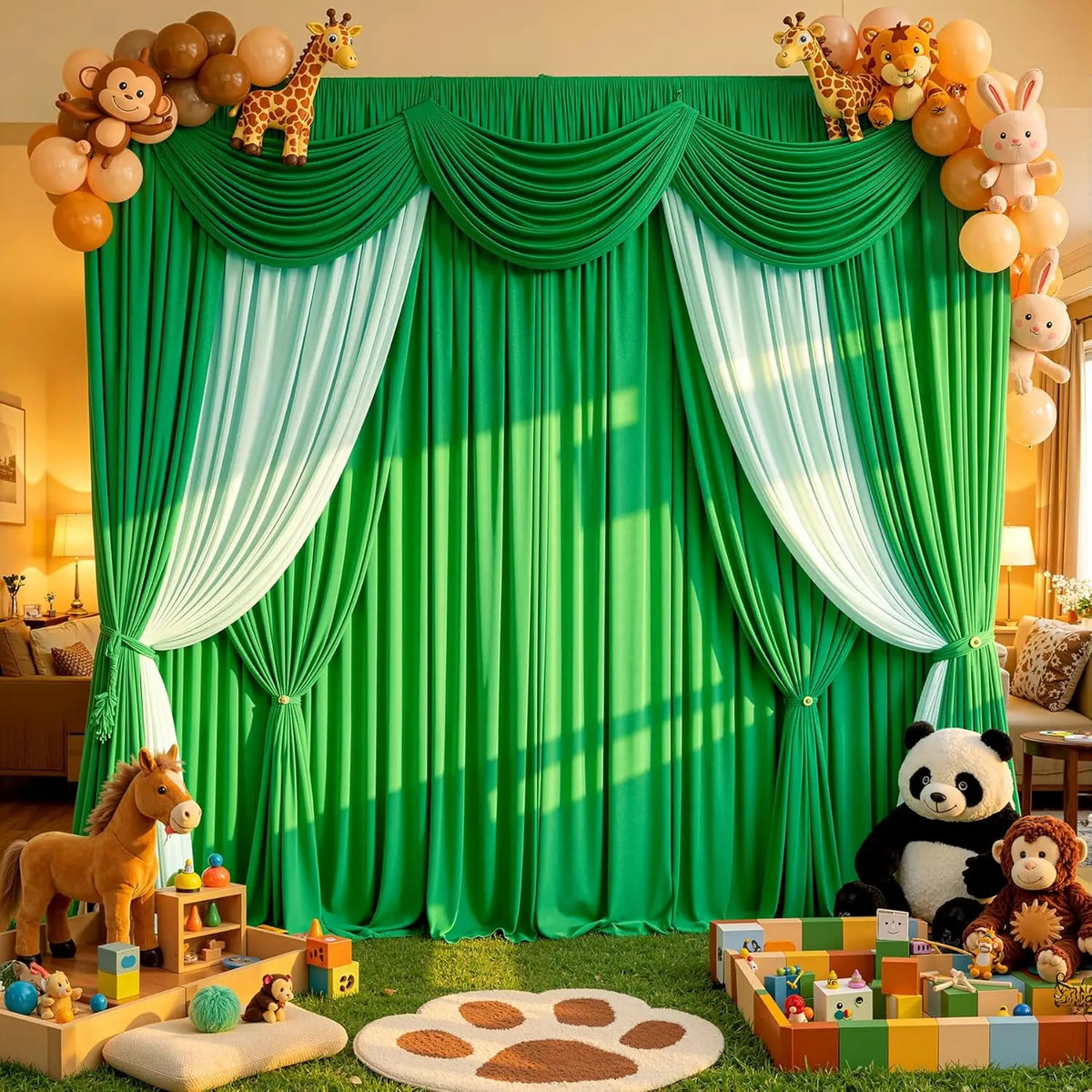 A green fabric backdrop with white draping and animal figures, set up for an event or photo shoot.