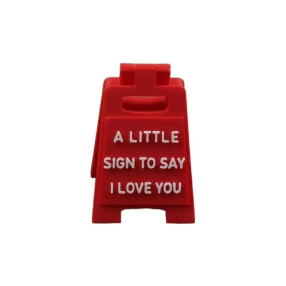 A red 3D printed letter sign ornament with the text A LITTLE SIGN TO SAY I LOVE YOU