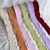 A collection of 10 yards of decorative fishtail yarn ribbon in various pastel and deep jewel tones.