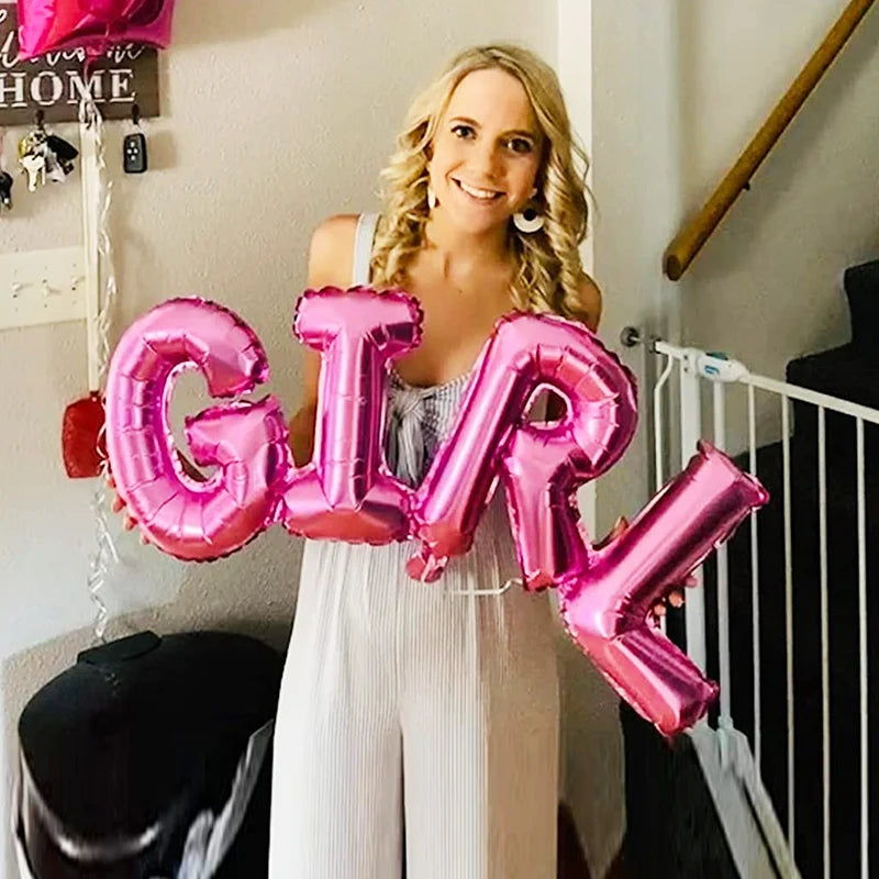 A smiling woman holds large pink foil letter balloons spelling 'GIRL' in a light-colored outfit.
