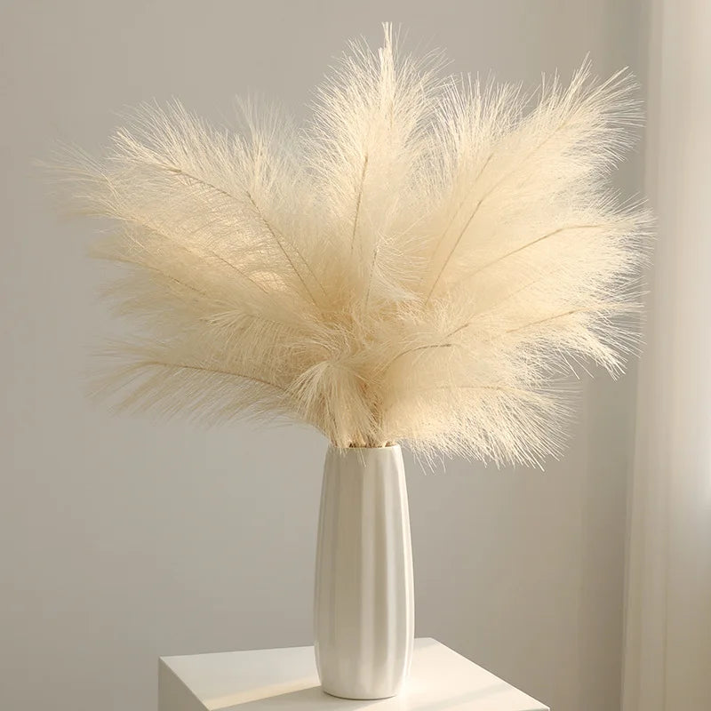 Dried beige pampas grass branches in a white vase used as boho home and wedding decor