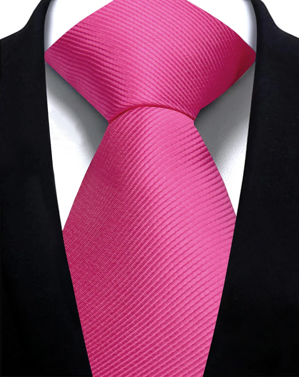 A vibrant pink silk necktie tied in a knot against a black suit jacket.