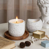 White textured silicone molds for candles, resin, and concrete displayed on a wooden surface.