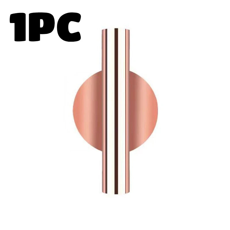 A modern wall-mounted flower vase featuring a rose gold finish with vertical stripes.