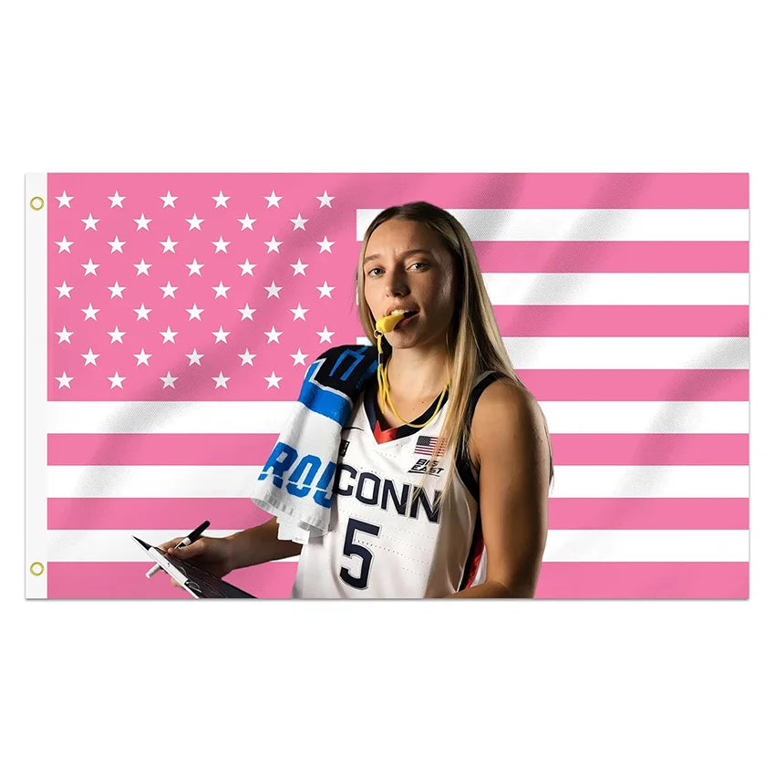 A female athlete in a basketball jersey is featured against a pink and white striped American flag background.