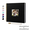 Black linen cover scrapbook album with a gold spiral binding and a photo of a couple.