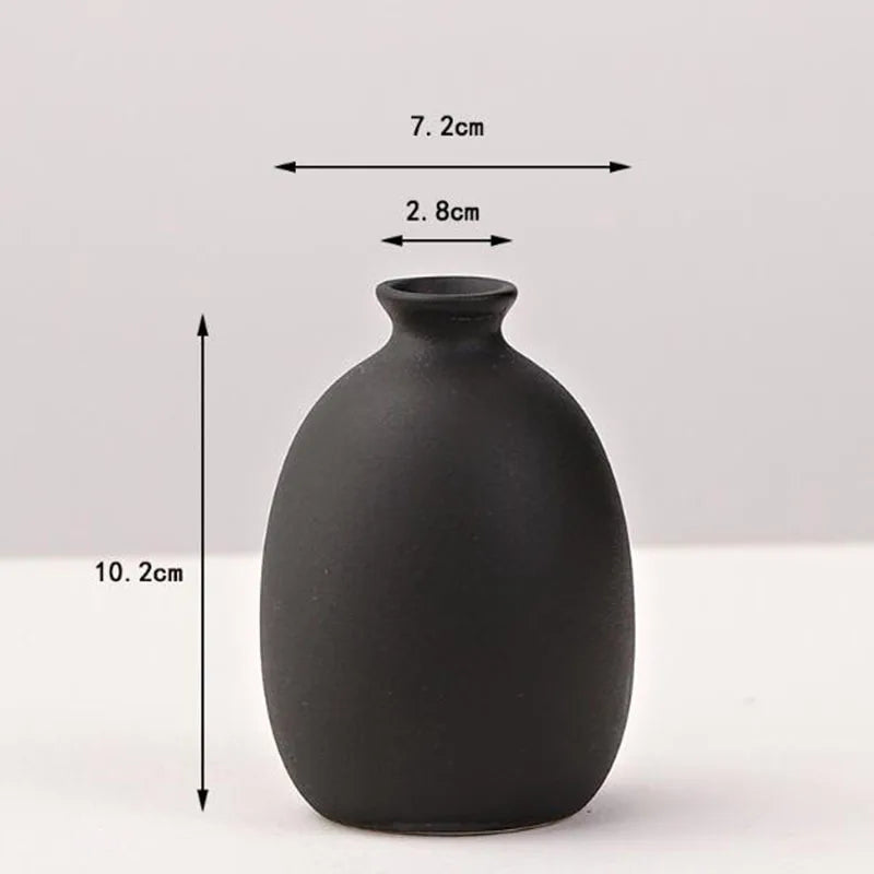 A matte black ceramic vase with a rounded body and narrow neck, shown against a white background.