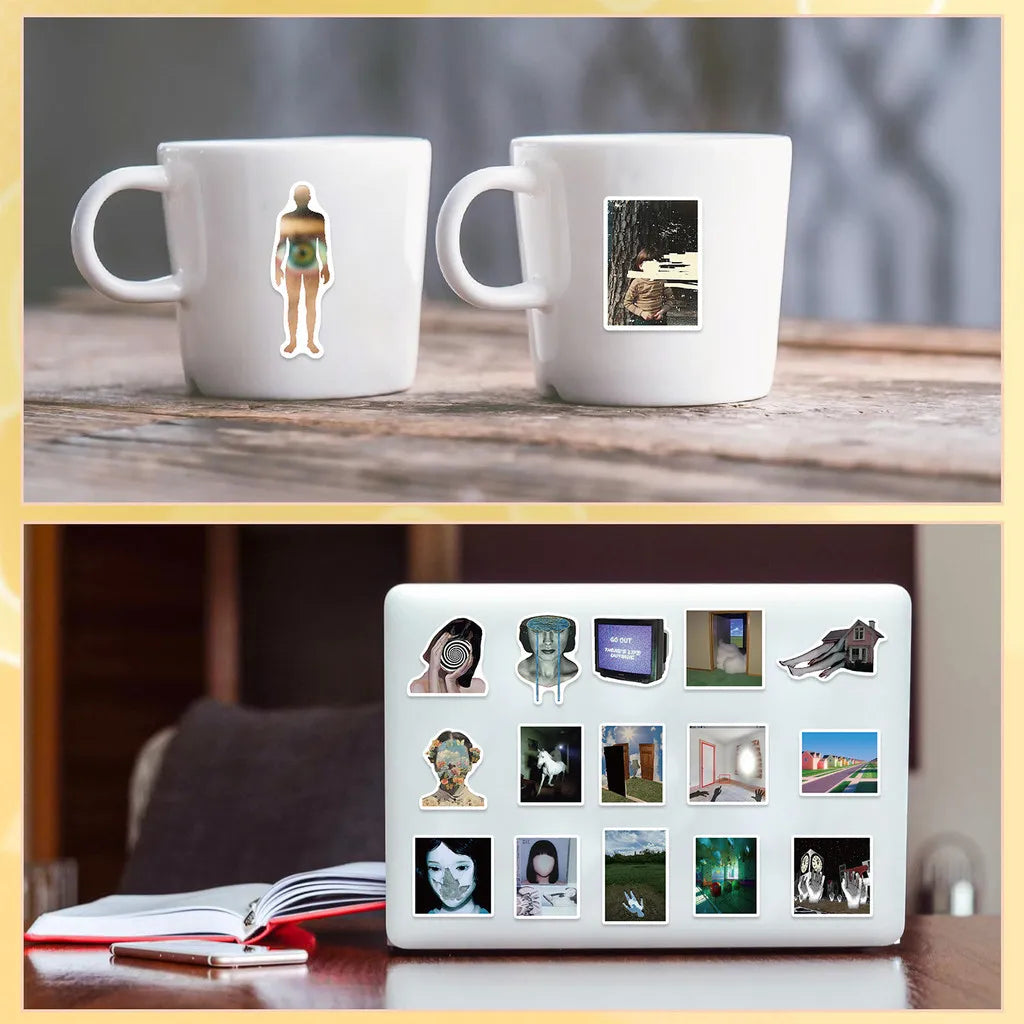 Two white mugs feature stickers of a female figure and a landscape, displayed on a wooden surface.