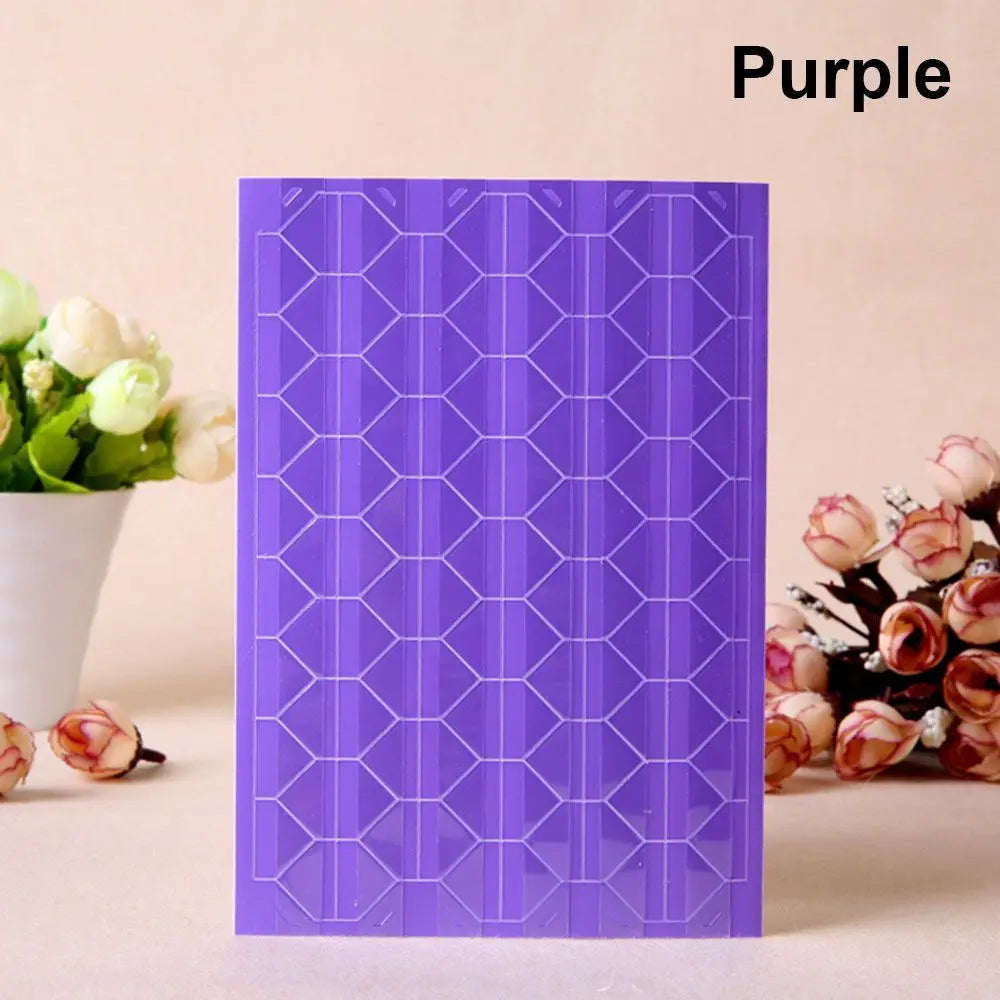 Purple PVC photo corner protectors with a geometric pattern displayed next to white flowers.
