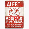 A distressed red metal sign with white text that reads ALERT and VIDEO GAME IN PROGRESS with a controller icon.