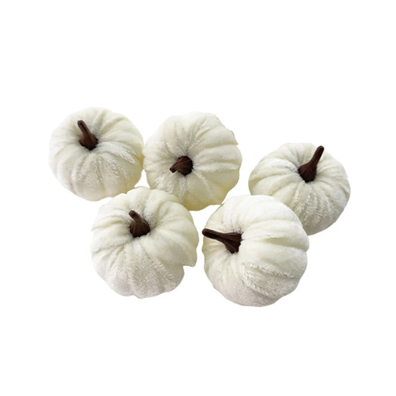 A set of five white, fluffy foam pumpkins used for Halloween decoration.