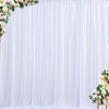 White wrinkle-free satin backdrop curtain with floral greenery and draping for parties and photography