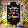 A classroom door banner decorated with a welcome back to school message, featuring hearts, stars, and a yellow sunflower arra