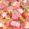 A close-up of colorful, translucent resin figures shaped like capybaras and other animals with a soft glow.