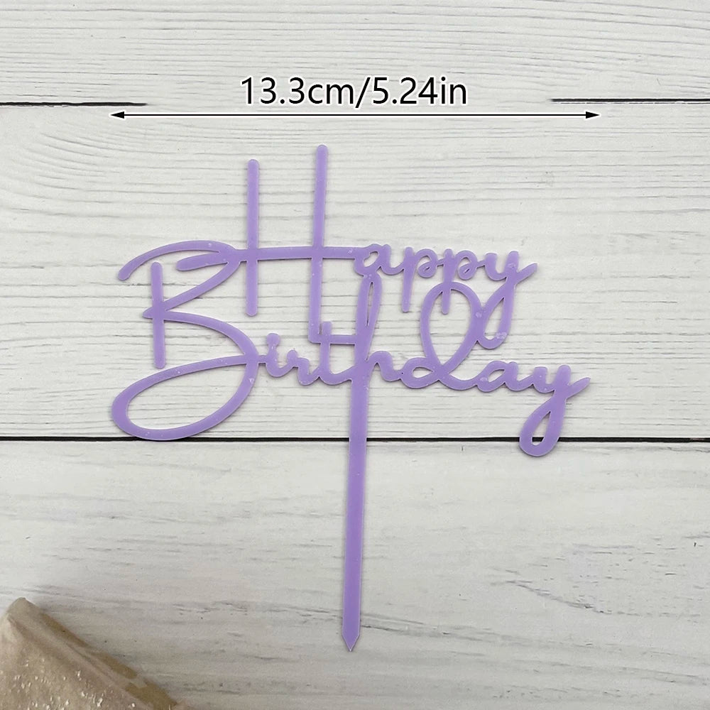 Purple acrylic birthday cake topper with happy birthday lettering and a stick.