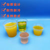 A collection of disposable mini tasting cups filled with various colored juices, including yellow, green, and orange.