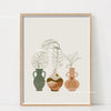 Botanical philodendron canvas wall art featuring potted plants in earthy tones framed in light wood