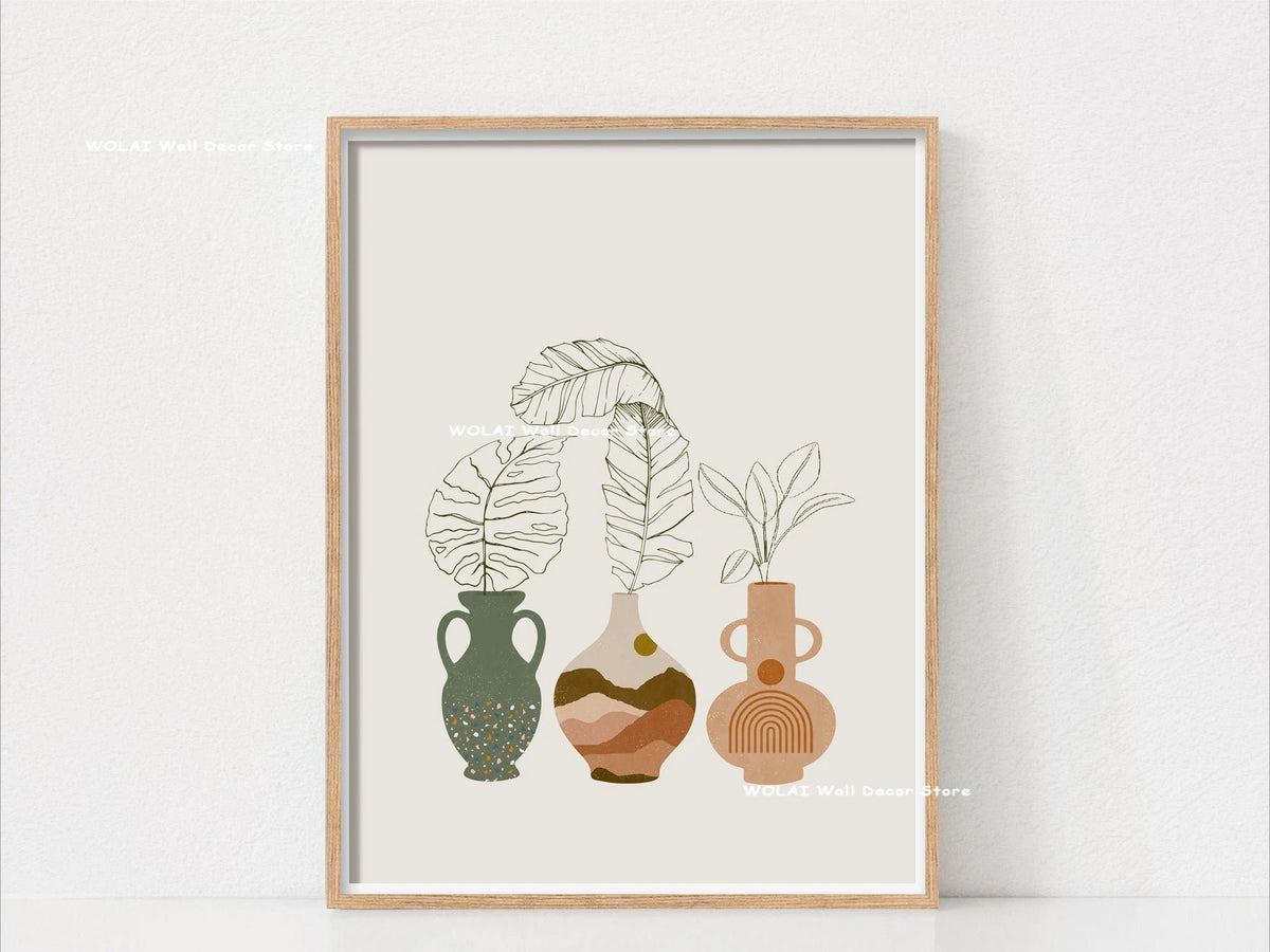 Botanical philodendron canvas wall art featuring potted plants in earthy tones framed in light wood