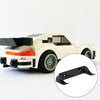 A white die-cast car model with a black wall mount display holder attached to the front bumper.