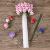A white foam flower arrangement cylinder featuring pink, red, and blue roses.