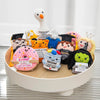 A collection of handmade crochet positive potato dolls with inspirational slogans and pocket hugs displayed on a white stand.