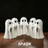 A pack of five white ghost figurines with playful poses arranged on a dark wooden surface.
