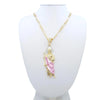 A gold-plated pendant necklace featuring a figure of Saint Jude on a white display bust.