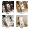 Four photo frames in different wood tones and finishes: dark brown, light wood, white wood, and pure white.