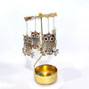 Gold rotating candle holder with a carousel of owl-shaped tealight holders.