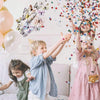 Three children joyfully interact with a set of 3D magnetic butterfly wall decor while celebrating.