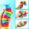 A hand holds a colorful, segmented fidget slug toy made of silicone in various bright colors.
