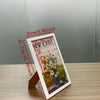 A set of three A4 solid wood picture frames with acrylic fronts displayed on a wooden surface.