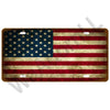 A vintage metal tin sign shaped like the American flag with distressed texture.