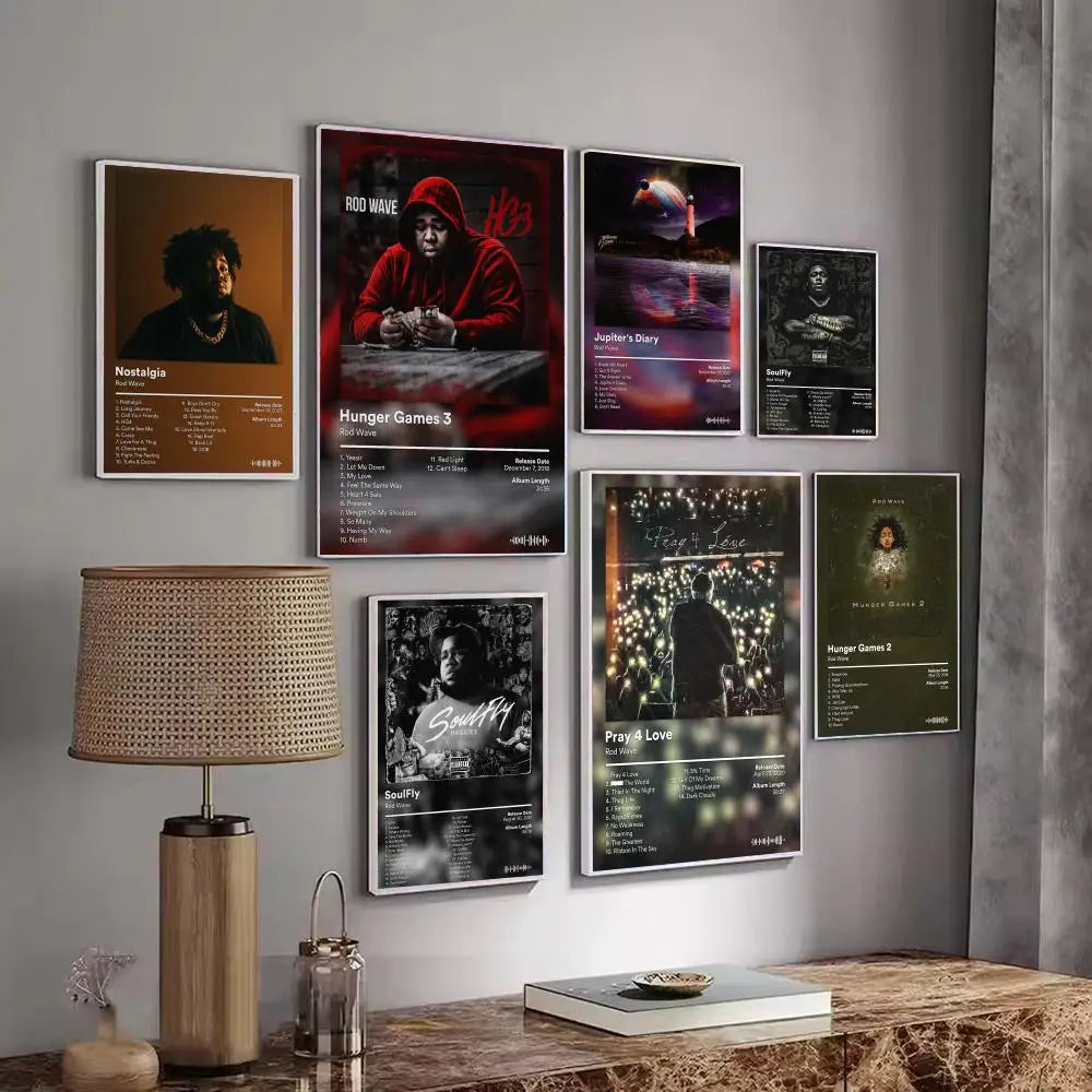 A gallery wall display of various rapper music album posters featuring dark and vibrant artwork.