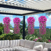 Pink artificial violet ivy hanging garlands decorating an outdoor patio or garden area.