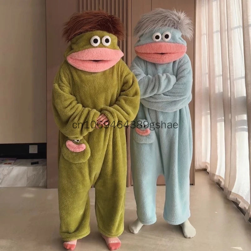A pair of fuzzy monster onesie pajamas for couples, one green and one blue.