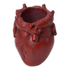 A reddish-brown resin heart-shaped pen organizer with detailed root-like texture.