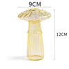 A tall, translucent yellow glass vase shaped like a mushroom with a textured cap.