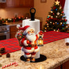 A festive Santa Claus figure decorates a white kitchen paper towel holder on a granite countertop.