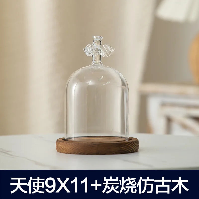 Clear glass aromatherapy candle holder with a dome shape and a wooden base