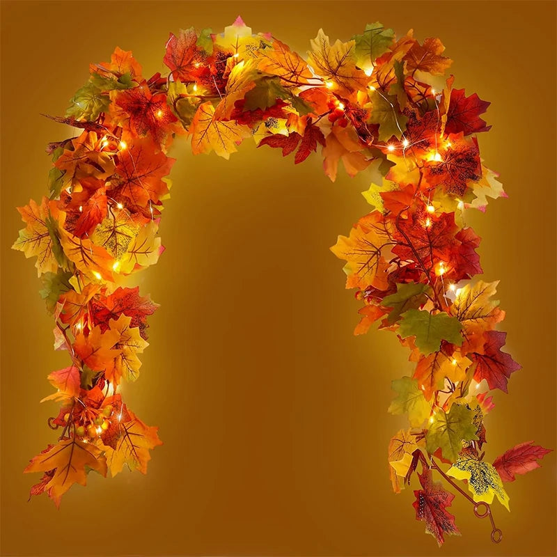 An archway decorated with glowing autumn maple leaves in shades of orange, red, and yellow.