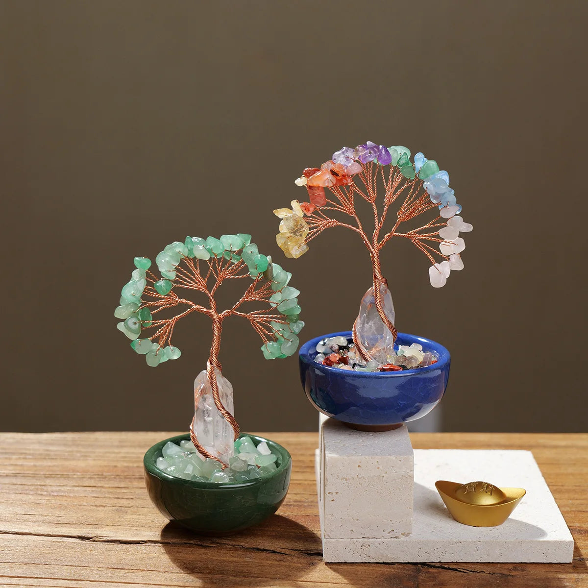 A natural crystal money tree with a rose quartz base featuring various colored crystals.