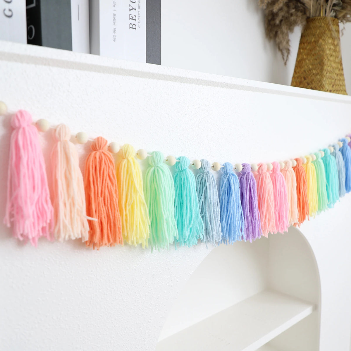 Handmade boho rainbow tassel garland with wooden beads featuring bright pastel colors