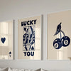 Three framed art prints featuring lucky symbols and text on a light beige background