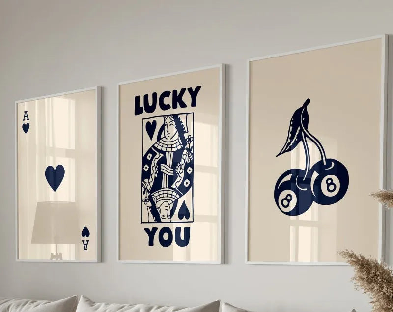 Three framed art prints featuring lucky symbols and text on a light beige background