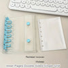 A clear plastic binder cover with inner pages and a white sheet protector is shown next to a white keyboard.