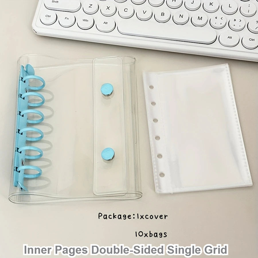A clear plastic binder cover with inner pages and a white sheet protector is shown next to a white keyboard.