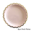 Eight 9-inch pink plates with gold trim for disposable party use