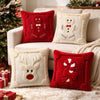 A collection of red and white Christmas-themed pillows, including gingerbread man, snowman, and candy cane designs, displayed