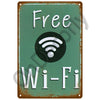 A vintage metal sign with a weathered green background and white text that reads Free Wi-Fi.